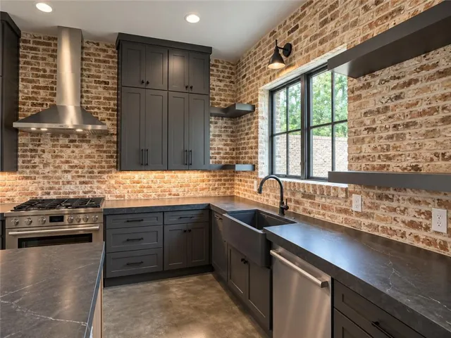 Industrial design elements merge seamlessly with modern cabinetry and textured brick walls.
