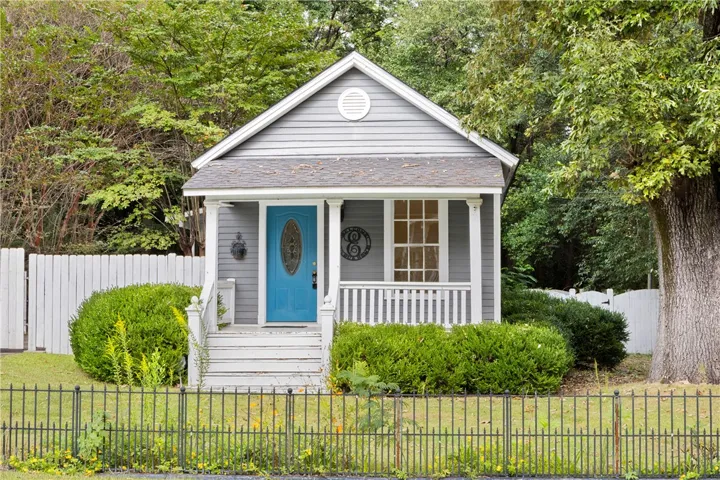 Welcoming front porch and classic siding define this charming residential facade.