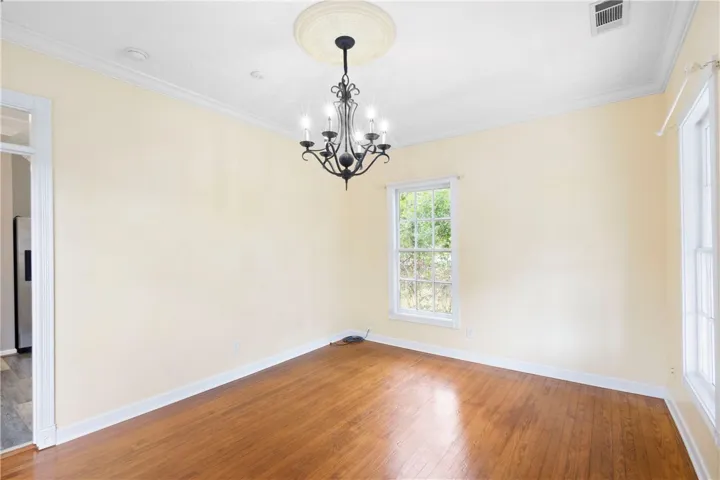 Gleaming hardwood floors and classic crown molding define this versatile dining space.