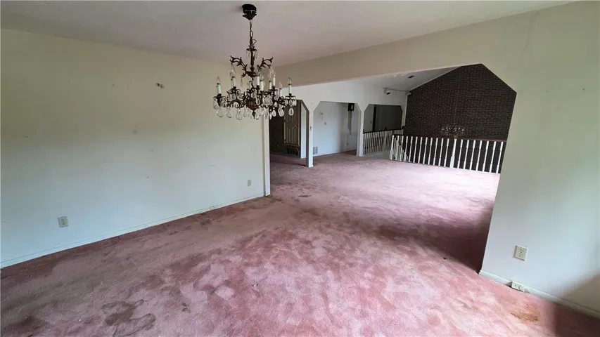 An open floorplan connects the primary living spaces under classic ceiling fixtures.