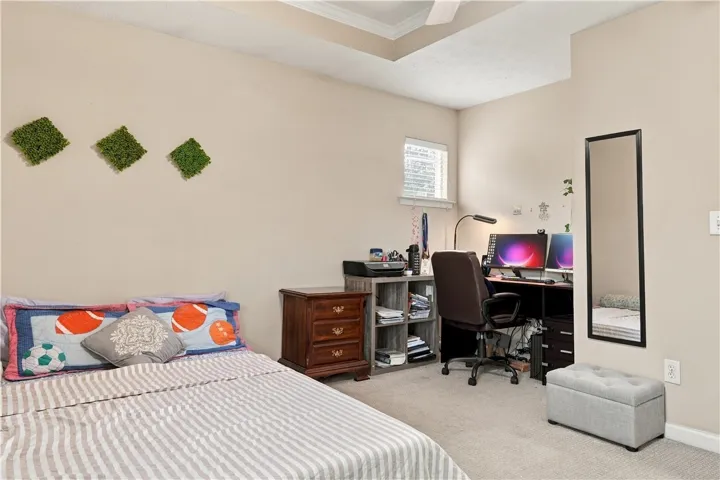 An overhead tray ceiling and soft wall finishes define this quiet bedroom retreat.