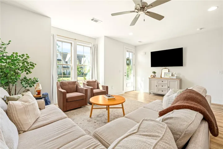 Tall windows define this open living area filled with natural light.