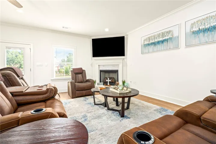 An inviting corner fireplace serves as the centerpiece of this comfortable living space.