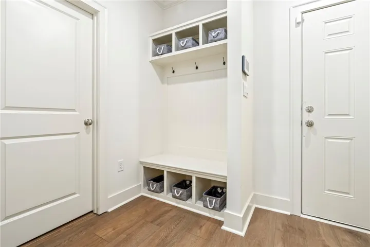 A functional drop zone near the entrance features built-in storage cubbies and bench seating.