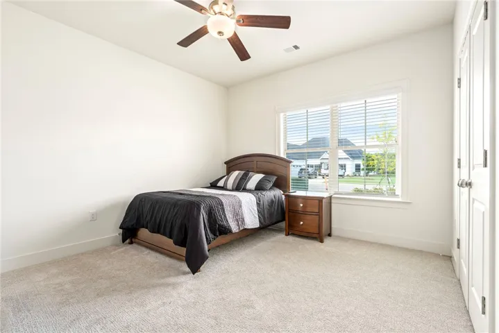 Plush carpeting and a large window creating a peaceful atmosphere in this cozy space.