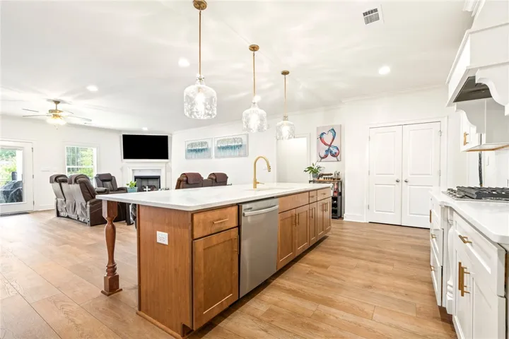 Gleaming floors and a spacious island anchor this light-filled culinary space.