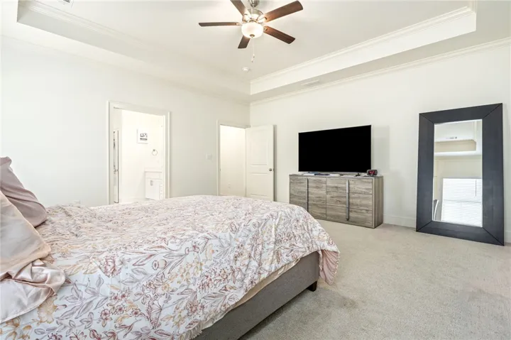 An elegant tray ceiling and soft wall-to-wall carpeting define this peaceful private retreat.