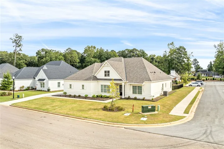 Elegant gables and clean siding define this classic craftsman-style exterior on a manicured corner lot.