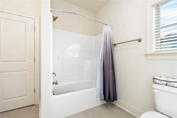 Clean lines and classic finishes define this functional bathroom space featuring a tub-shower combination.
