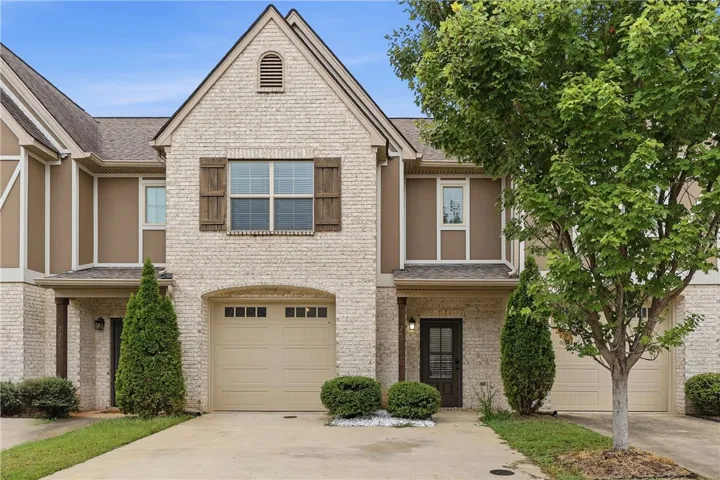 Timeless brick and siding exterior elements define this multi-level townhouse design.