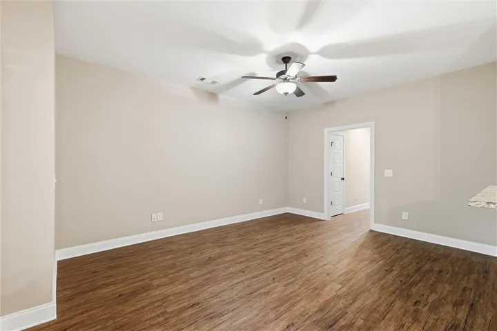 Rich wood-look flooring and crisp white trim create a clean canvas for your design ideas.