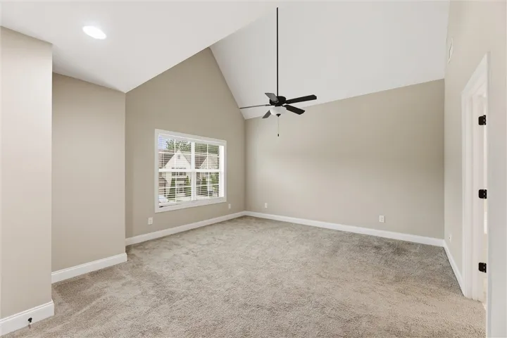 High vaulted ceilings and plush carpeting anchor this versatile upper-level space.