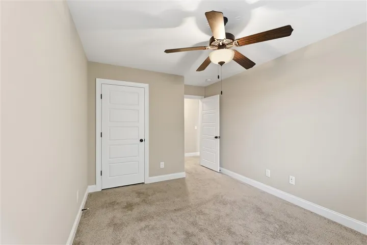 Soft carpeting pairs with neutral walls to create a comfortable and inviting private retreat.