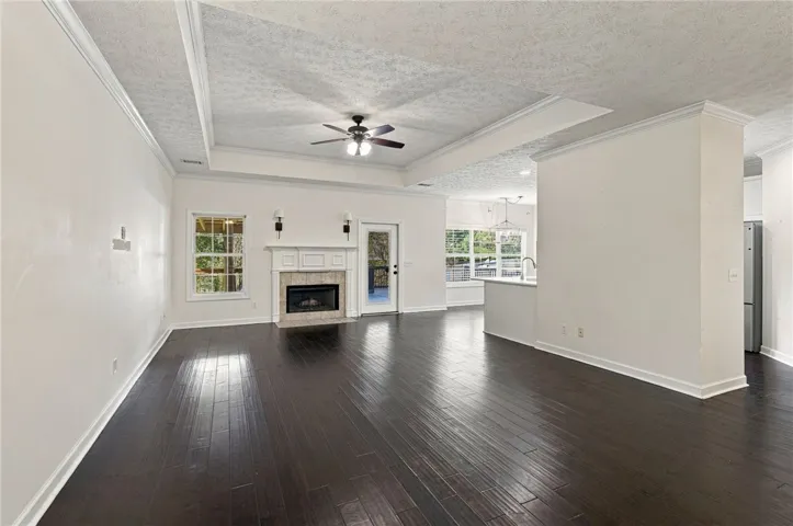 Rich dark wood floors anchor an airy, open layout complete with a classic focal fireplace.