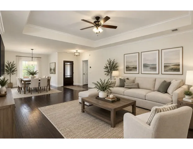 Rich hardwood flooring anchors the open-plan layout, framed by crown molding and recessed ceiling details.