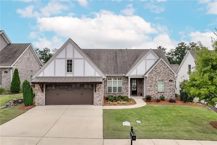 Stately brick and timber design defines the exterior of this timeless multi-gabled home.
