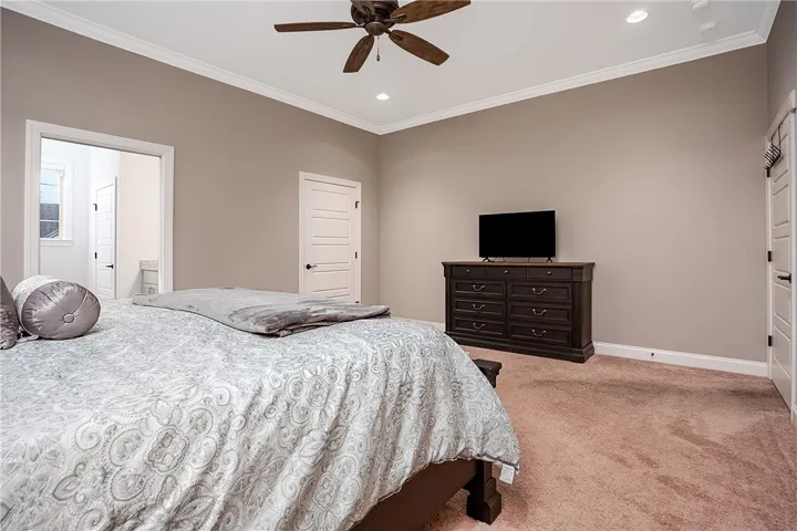 Crisp crown molding accents the clean lines and wall-to-wall carpeting of this quiet retreat.