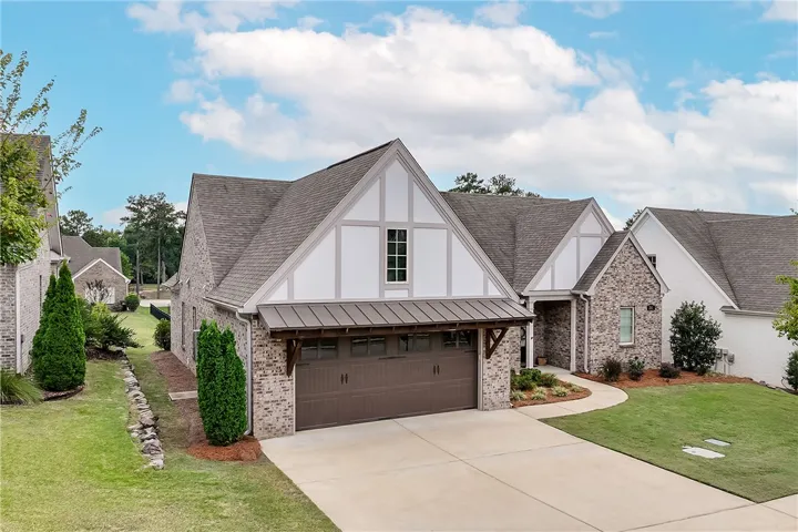 Striking brick and Tudor-inspired architectural details define this modern home's exterior design.