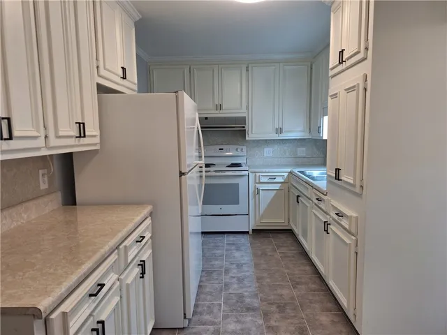 Ample cabinetry and durable flooring define this highly functional workspace.