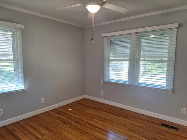 Gleaming hardwood floors and classic crown molding define this versatile, light-filled room.