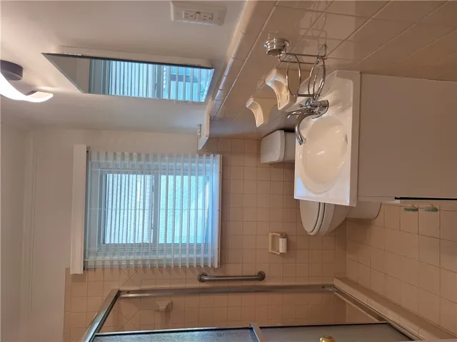 Tiled walls and a walk-in shower frame this functional space.
