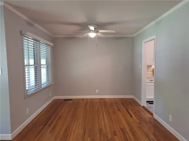Gleaming hardwood floors and classic crown molding define this versatile living space.