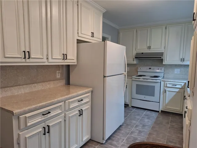 Crisp cabinetry and durable flooring define this functional workspace.