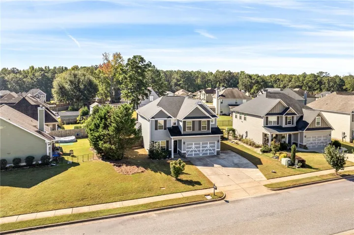 A well-maintained neighborhood setting highlights this traditional two-story home with an attached garage.
