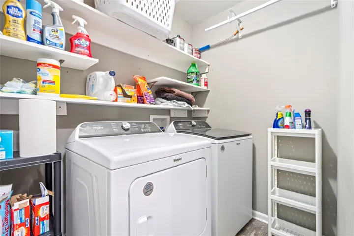 Functional utility space features built-in shelving overhead and resilient modern flooring.