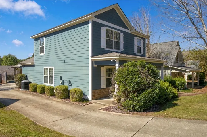 Crisp trim accents the classic siding of this two-story home beside a concrete driveway.
