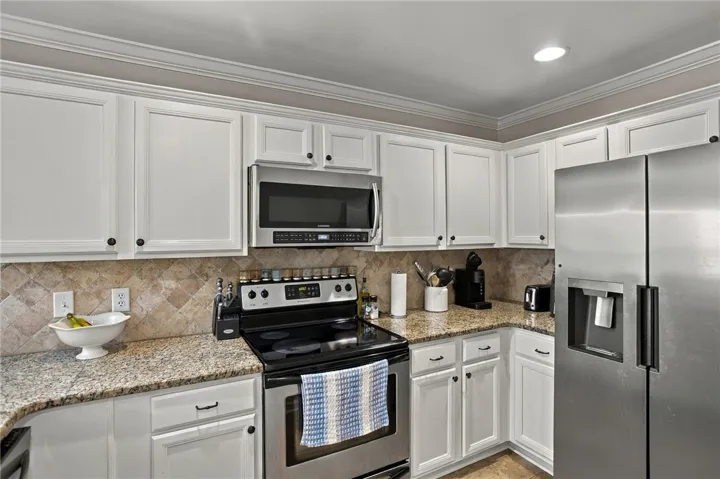 Timeless crown molding and stone counters define this classic culinary space.