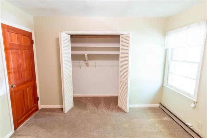 Plentiful closet shelving and comfortable flooring highlight this functional space.