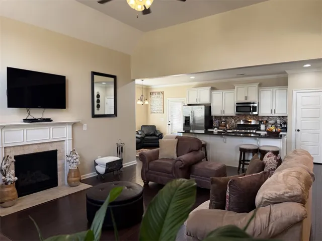 A spacious layout connects the living room and kitchen beneath a soaring vaulted ceiling.