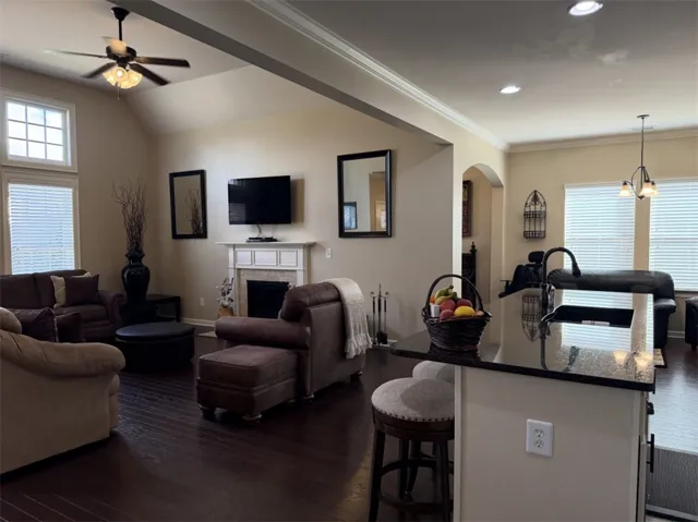 An open floor plan connects the kitchen island to the living room with fireplace.
