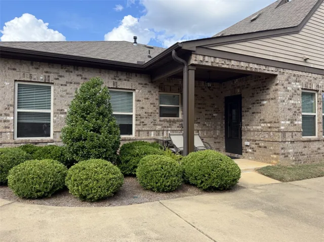 A welcoming brick entryway with a covered porch provides classic curb appeal.