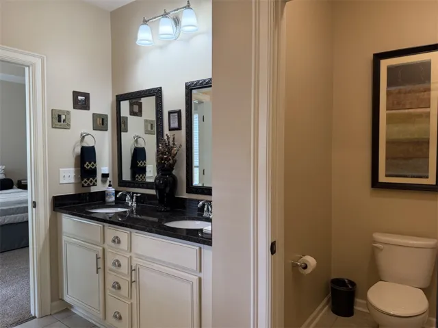 A classic double vanity with stone countertops highlights this functional bathroom space.