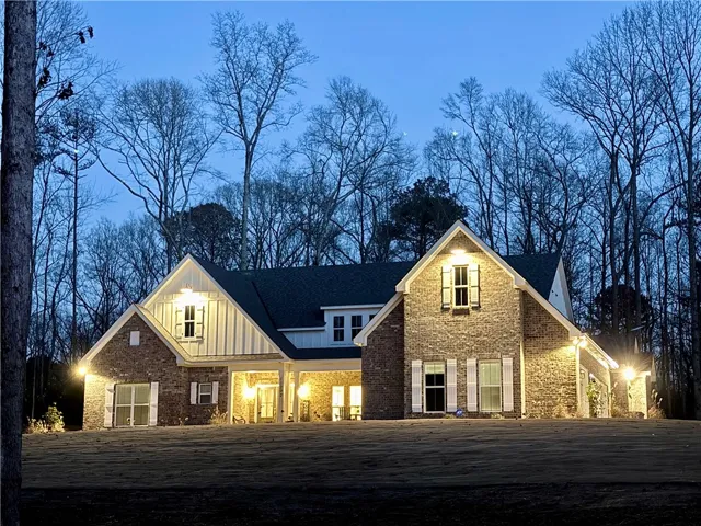Gable rooflines and classic brick cladding define the facade of this elegant multi-level home.