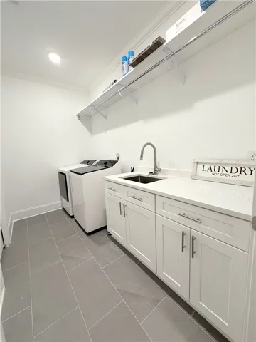 An organized utility workspace highlights clean tile flooring and built-in storage cabinets.