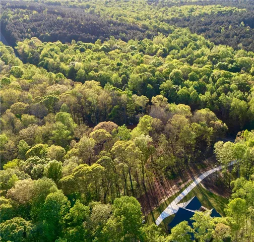 Mature woodlands wrap this private property in a peaceful canopy of natural beauty.