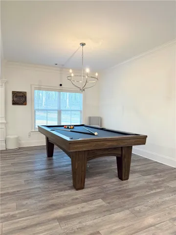 Elegant crown molding complements clean lines and handsome wood-look flooring in this versatile space.