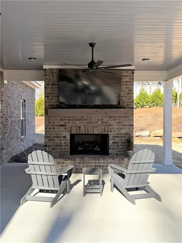 A handsome brick fireplace serves as the centerpiece of this covered outdoor living space.