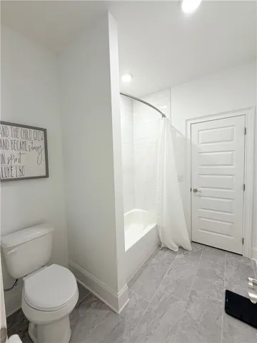 Clean lines and classic tiling define this functional bathroom layout.