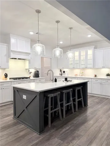 Modern cabinetry and a central island anchor this open-concept kitchen under recessed lighting.