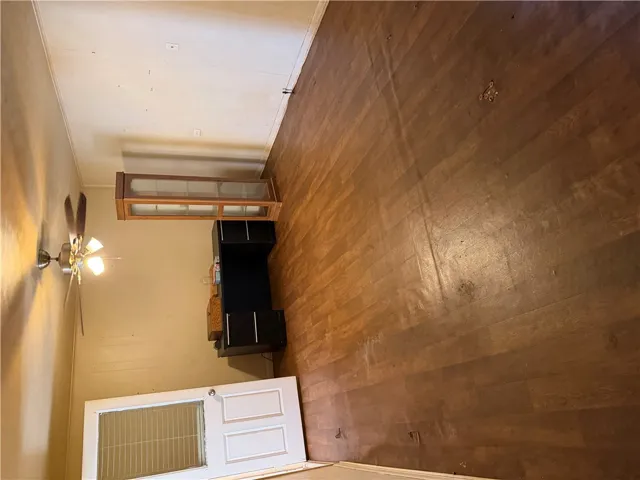 Rich wood-look flooring anchors this versatile space, ready for your personal design touch.