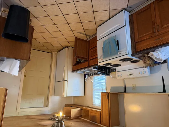 Ample wooden cabinetry and tile flooring define this functional kitchen space.