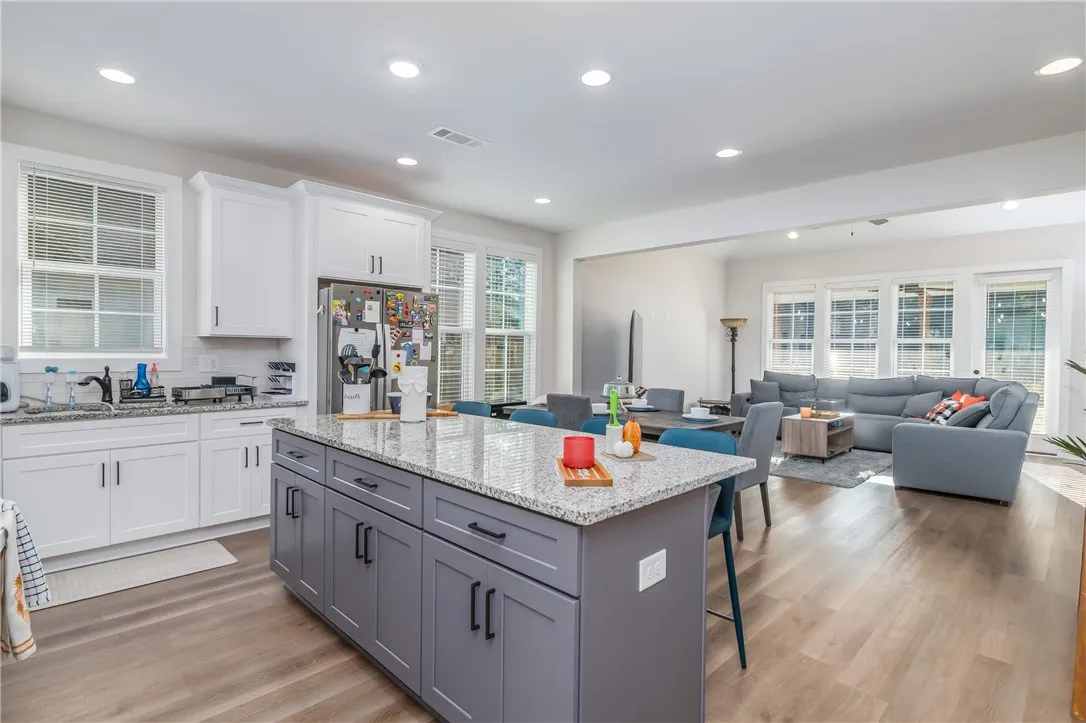 An open-concept layout connects the kitchen seamlessly to adjacent dining and living areas.