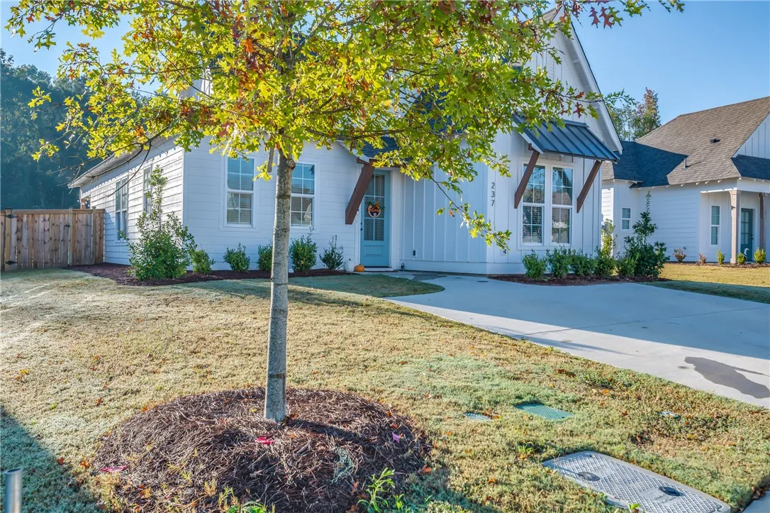 Crisp board and batten siding pairs beautifully with clean architectural lines and professional landscaping.