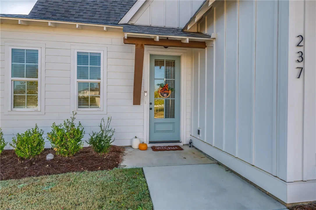 A welcoming front entry features modern board and batten siding paired with classic horizontal lap accents.