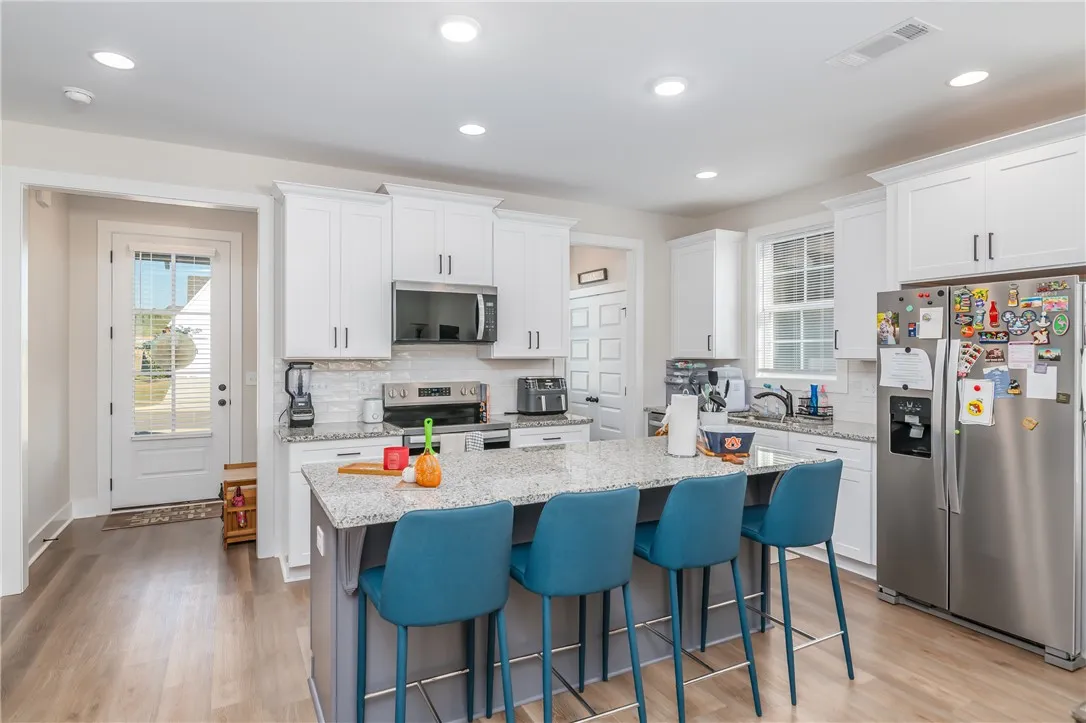 Gleaming stone countertops and recessed lighting elevate this modern culinary space.