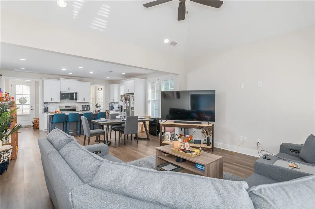 An airy open-concept layout unites the living area with the dining space and kitchen.